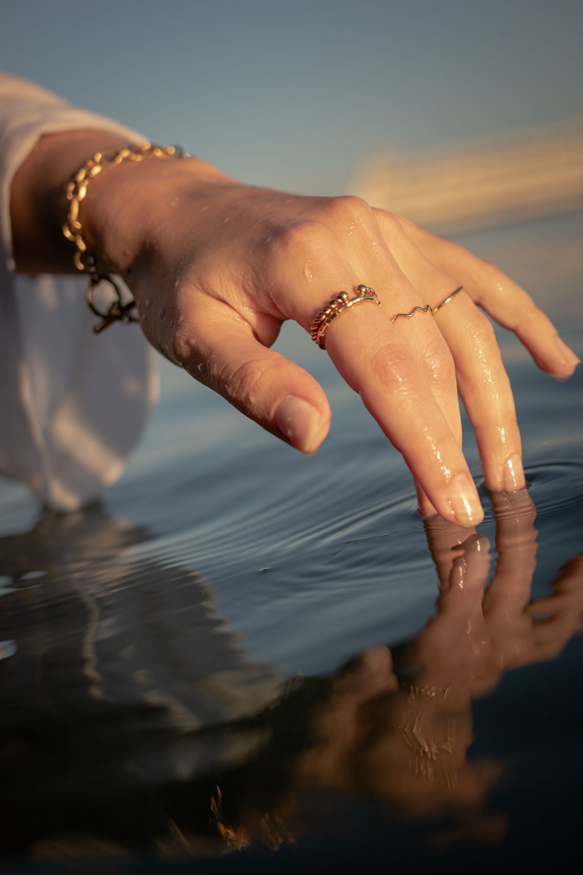 PVD coated stainless steel jewelry on wrist at the beach